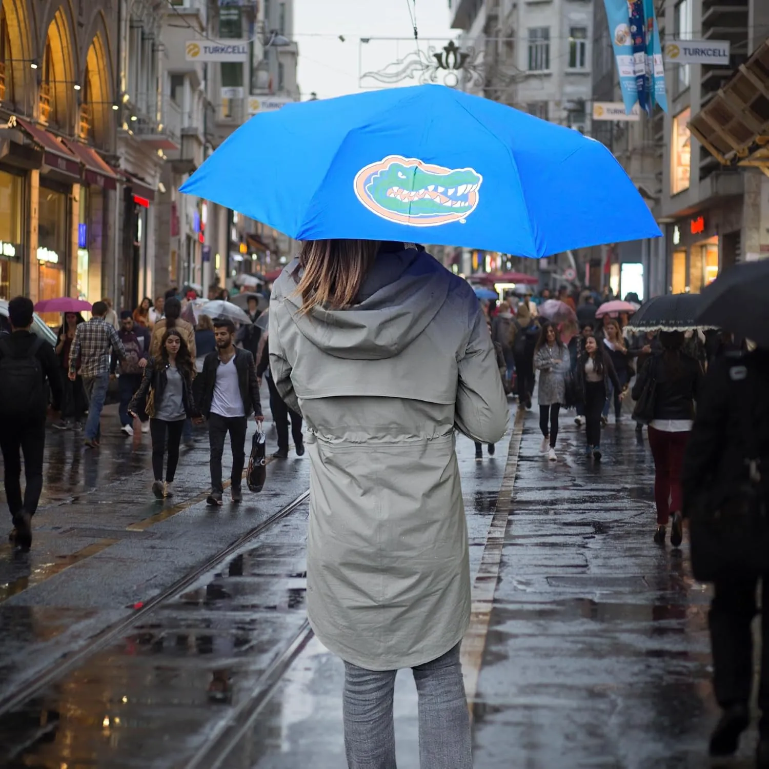 Mini Compact Storm Umbrella - NCAA Logo 42” Coverage, Folds to 11 Inches- Swivel Clip on Handle - Water, Wind & Rust Resistant, and Flexible Frame